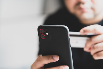 Man using credit card and paying via mobile banking app. Internet payment, online shopping, concept.