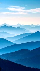 Fototapeta premium Layered mountain ranges are fading into the horizon with atmospheric perspective and cool blue tones