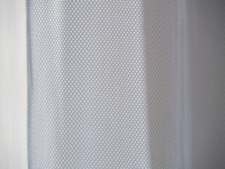 Tulle close-up against the light. Overlay background wallpaper. Luxury Texture Design. Stylish fashion backdrop. 
