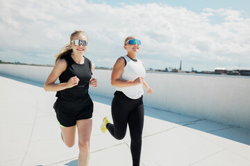 Joyful runners savoring sunlight on a rooftop during a vibrant afternoon workout session