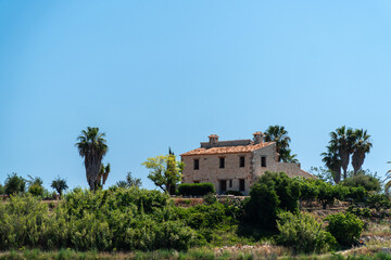 Fototapeta premium Country house in the hill on a sunny morning, Mediterranean style, in Comunidad Valenciana (Spain)