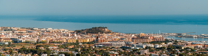 Panoramic view to Denia city and the Mediterranean sea in the morning.