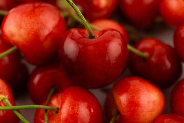 shot captures a generous pile of fresh, ripe cherries, highlighting their vibrant red hues and natural texture. Perfect for food photography, healthy recipes, or farmers' market promotions