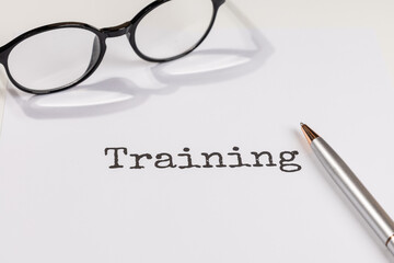 Training Document on Desk with Pen and Eyeglasses &ndash; Learning & Development Concept