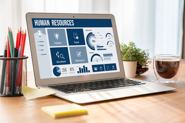Human resources management software on computer screen helping human resources employee to manage...