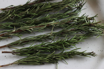 dry rosemary herb lies in a plate