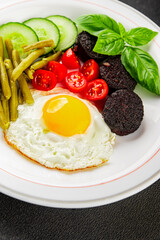 English breakfast fried egg, black pudding, vegetables, beans fresh delicious gourmet food...