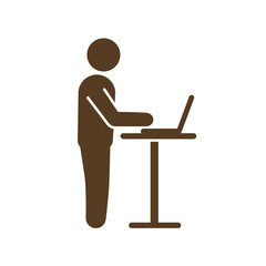 Person standing and working on laptop at a standing desk  