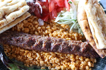 Close-up of traditional Turkish shish kebabs on oval plate	