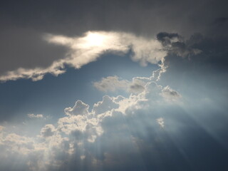 A bright sun breaks through the storm clouds, emitting an array of heavenly sunbeams. Stormy skies...