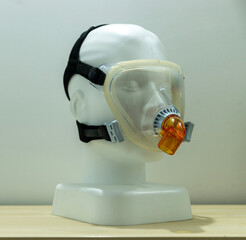 A full-face CPAP mask for respiratory use, mounted on a white mannequin head with no distinctive...
