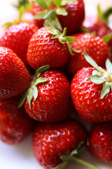 fresh strawberries with green leaves, close up photo