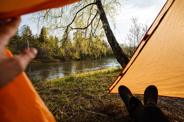 Experience the tranquil serenity of camping by the serene river, surrounded by natures warm embrace, where adventure awaits amidst beautiful landscapes and opportunities for blissful relaxation