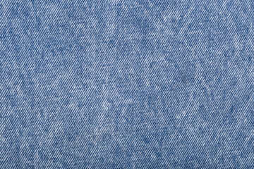 The denim is light blue. Denim background.