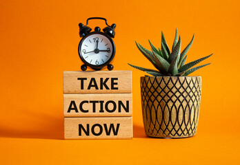 Take action now symbol. Wooden blocks with words Take action now. Beautiful orange background with...