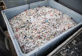 Colorful granulated plastic flakes in box