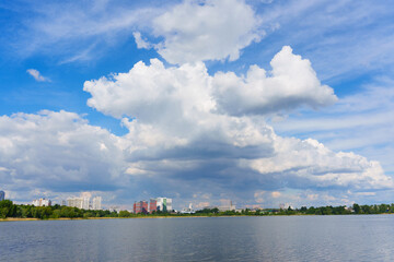 Scenic View Of Kyiv Skyline Reflected In Calm Water Under Cloudy Sky