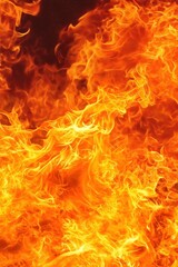 Fototapeta premium Bright flames dance in an intense fire showcasing shades of orange and yellow