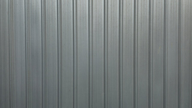 Silver metal sheet wall of factory, shiny metal wall texture, warehouse wall, texture, and background image.
