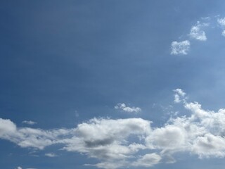 Dynamic composition of pure white clouds, textured against a bright blue sky, unique clouds, weather, bright, suitable for atmospheric backgrounds, or as an eye-catching design element.