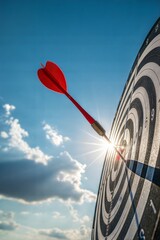 Red dart hitting bullseye against blue sky and sunlight, metaphor for business success