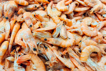 Freshly cooked shrimp served in a seafood market on a sunny afternoon