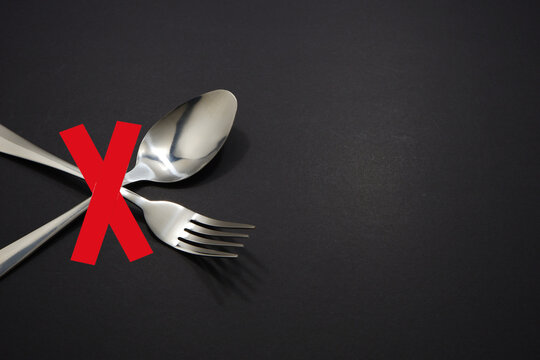 Set of forks isolated on dark background close-up view with don't use sign, Food conceptual photography 