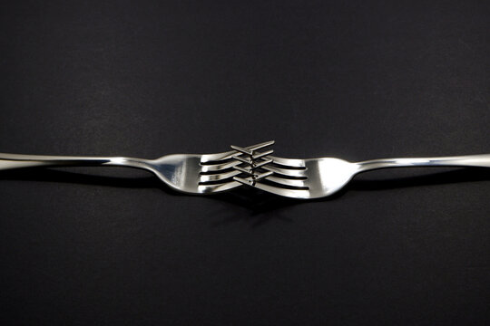 set of forks pairing together isolated on black background close-up view, Food concept photography