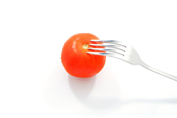 Fork on tomato closeup shot  with white background