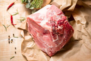 Raw Pork meat fillet. Fresh Pork meat, piece of meat close up. Prime filet meat texture. Chilled pork Boston butt, collar, shoulder. Steak. Raw pork neck, Spices. On wooden table background. Top view