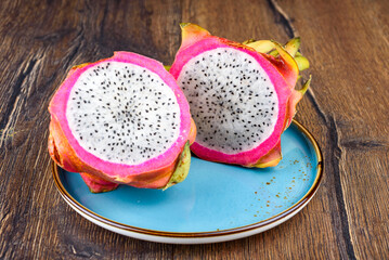 Two halves of Dragon Fruit on a blue plate