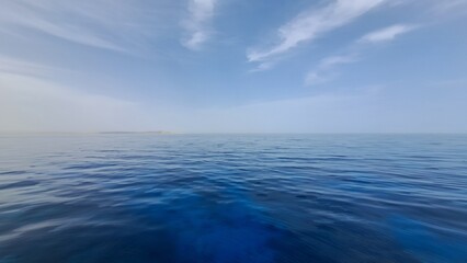 Obraz premium Expansive ocean view with calm blue waters reflecting the sky, creating a serene atmosphere, ideal for relaxation and tranquility in nature's beauty