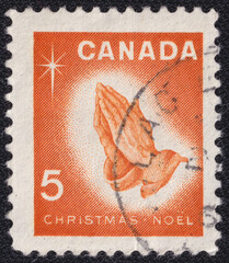 Praying Hands and the words Christmas Noel on a 1966 Canada postage stamp