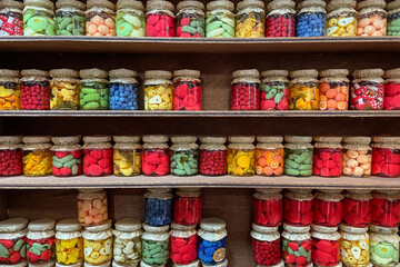 Small glass jars with decorative assorted sweets, in the form of canned fruits and vegetables
