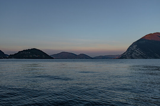 Sunrise painting the sky over Lake Iseo, in Lombardy, Italy.