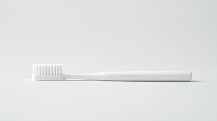 Minimalist composition featuring a single white toothbrush on a clean white background