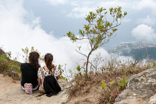 Two girls watching the impressive view of the sea from Picacho de Galipan El Avila Waraira Repano Caracas Venezuela.