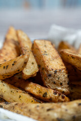 Freshly Baked Potato Wedges Pulled from Oven. Crispy Herb Seasoning
