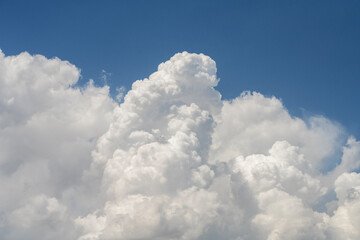 Blue sky with fluffy white close up clouds.. Clouds background.