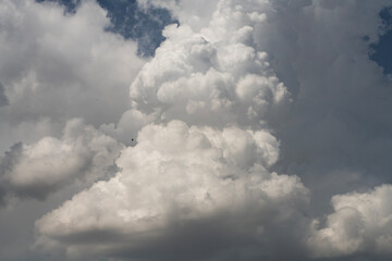Blue sky with fluffy white close up clouds.. Clouds background.