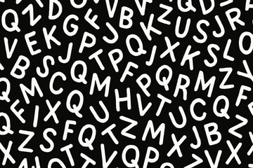 Abstract letter pattern background. Seamless typography, chaotic alphabet characters. Handwritten white letters on black. Educational, literacy, learning. Doodle sketch style font design. Texture.