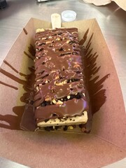 Paleta covered on hot fudge, nuts and oreos