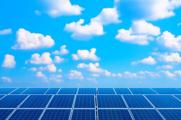 A panoramic view of solar panels under a clear blue sky with soft, white clouds.