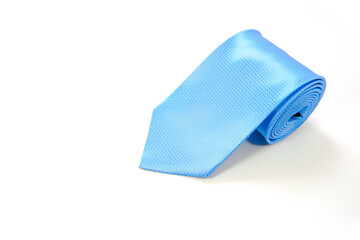 A blue tie rolled on white background closeup shot 