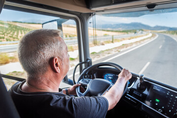 Aging truck driver behind the wheel, experienced but with slower reflexes, highlighting road safety...