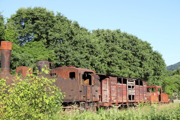 old rusty locomotive abandoned in a field