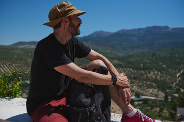 Traveler Enjoying Scenic Mountain Views While Resting in Nature