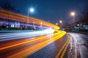 Motion blur from car taillights and headlights on a city road at night. Urban street with light trails showing transportation speed and movement.