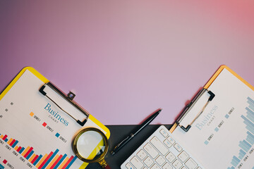 Flat lay of Business Analysis Tools with Charts and Magnifying Glass on a Vibrant Background for...