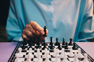 Chess Game. Focused Player Moves Black King Piece in an Intense Chess Game on a Stylish Board